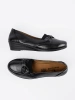 Black slip-on loafers with a bow