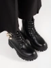 Black combat boots with a gold chain