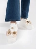 White and gold sneakers with gold accents