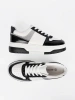 Black and white sneakers with shimmering silver details