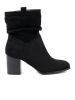 Black suede ankle boots on a column heel with ruched upper