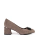 Beige block heeled pumps with a bow