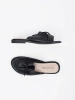 Black flat slides with a bow