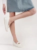 White platform loafers with gold embellishment