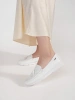White fringe loafers on low wedge