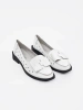 White perforated shoes with a bow