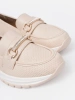 Light beige moccasins with decorative gold element