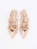 Beige patent pumps with gold accents